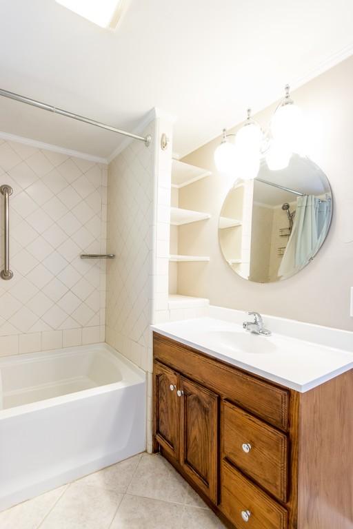 full bath with vanity, tile patterned floors, shower / bath combo with shower curtain, and ornamental molding