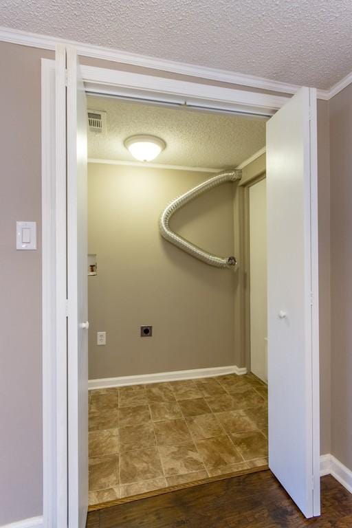 washroom featuring a textured ceiling, wood finished floors, visible vents, and electric dryer hookup