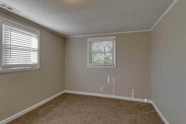 spare room with plenty of natural light, baseboards, visible vents, and carpet floors