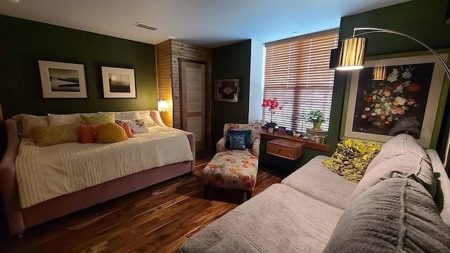 bedroom featuring visible vents and wood finished floors