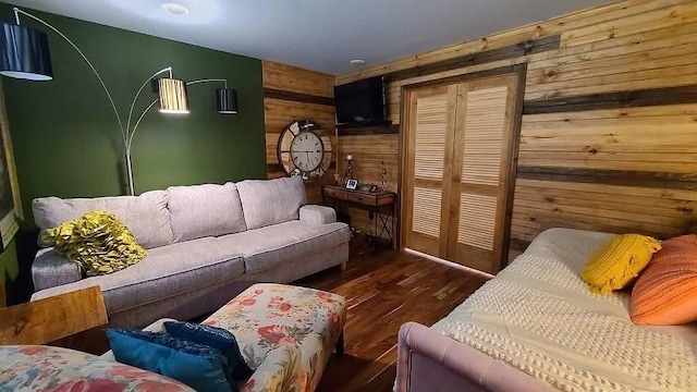 living area with wooden walls and wood finished floors