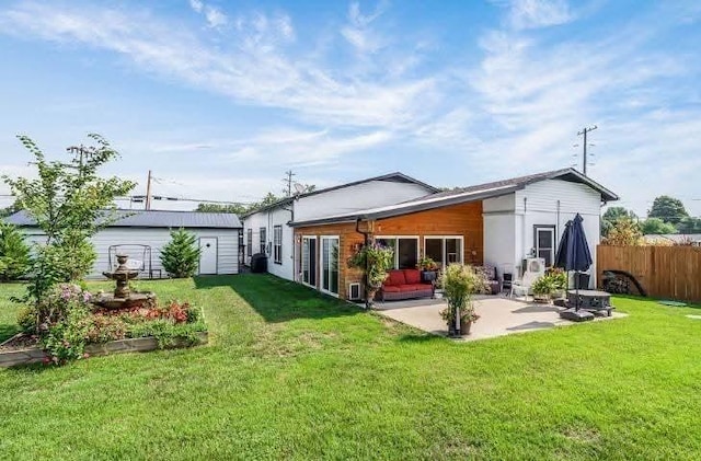 rear view of house with a yard, a patio, and fence