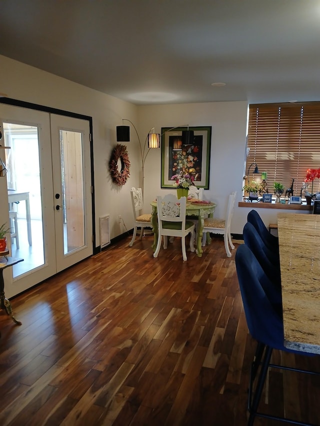 dining area with french doors and dark wood-style floors