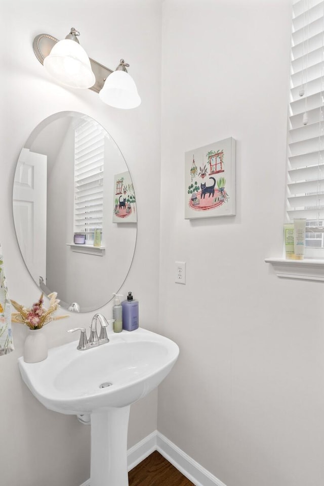 bathroom featuring baseboards and wood finished floors