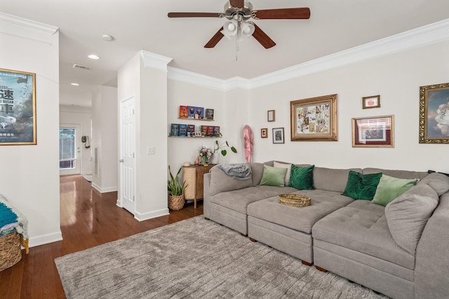 living area with crown molding, hardwood / wood-style flooring, baseboards, and ceiling fan