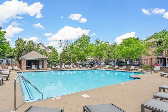 pool featuring a patio area and fence