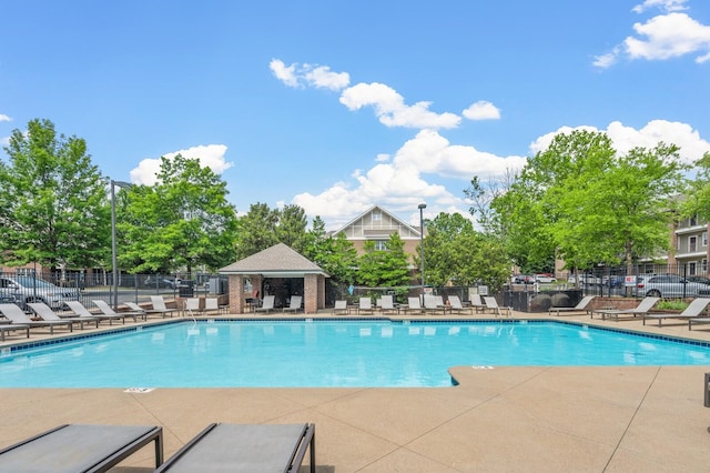 community pool featuring a patio area and fence