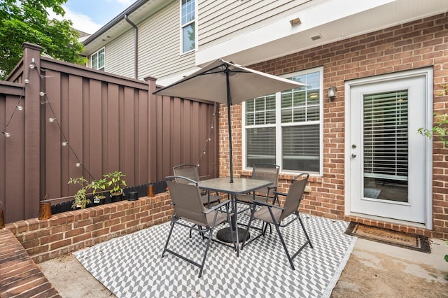 view of patio / terrace with outdoor dining space and fence