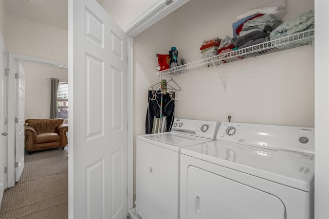 washroom with light carpet, laundry area, and washing machine and dryer