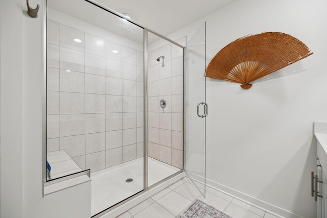 full bath with baseboards, a stall shower, and tile patterned flooring