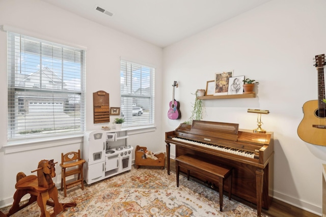 living area featuring visible vents and baseboards