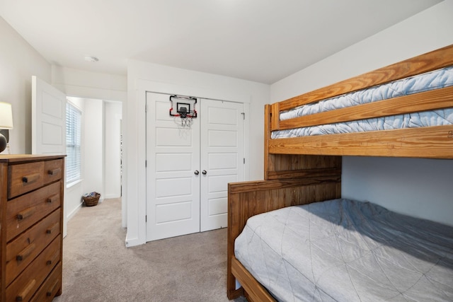 bedroom featuring a closet, carpet floors, and baseboards