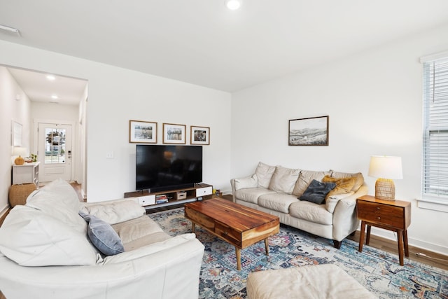 living room with plenty of natural light, wood finished floors, recessed lighting, and baseboards