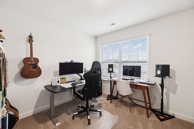 home office with visible vents, baseboards, and light colored carpet