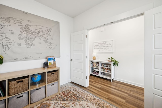 interior space featuring baseboards and wood finished floors