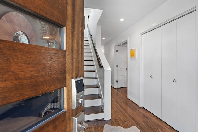 stairs featuring recessed lighting, wood finished floors, and baseboards