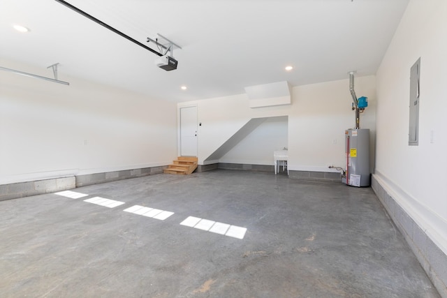 856 Tucker Rd, Dickson, TN 37055 - garage with water heater, a garage door opener, electric panel, and recessed lighting
