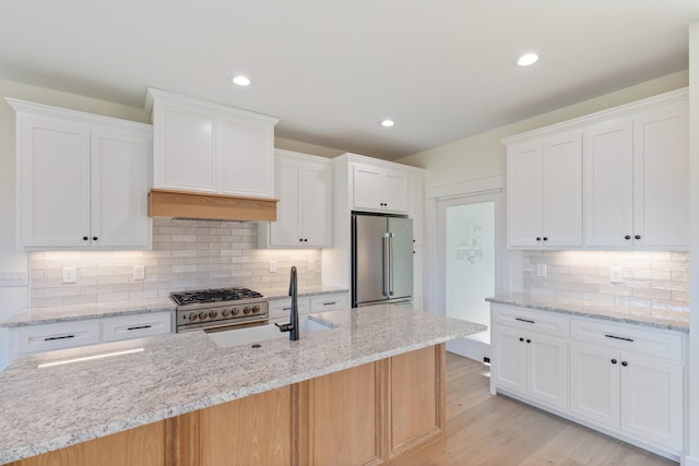856 Tucker Rd, Dickson, TN 37055 - kitchen with high quality appliances, tasteful backsplash, white cabinetry, light wood-style flooring, and recessed lighting
