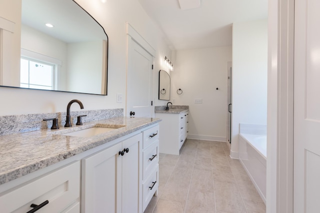 856 Tucker Rd, Dickson, TN 37055 - full bath featuring two vanities, a garden tub, and tile patterned flooring