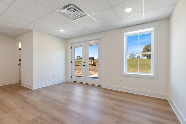 856 Tucker Rd, Dickson, TN 37055 - empty room featuring french doors, a drop ceiling, light wood finished floors, and recessed lighting
