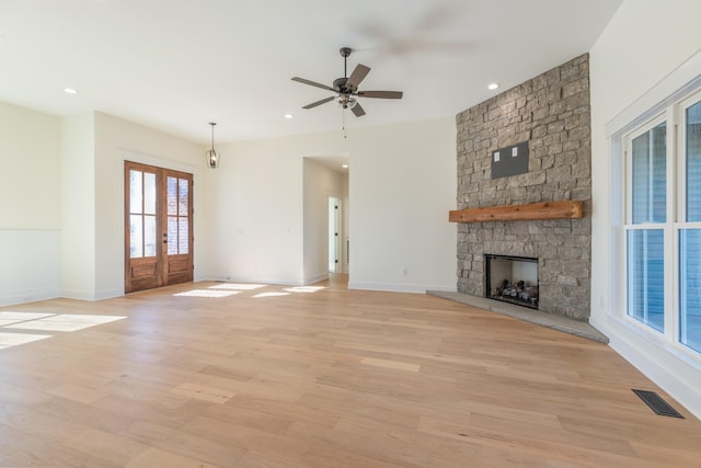 856 Tucker Rd, Dickson, TN 37055 - unfurnished living room with ceiling fan, light wood-type flooring, french doors, a stone fireplace, and recessed lighting