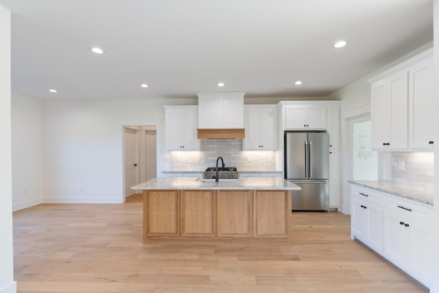 856 Tucker Rd, Dickson, TN 37055 - kitchen with freestanding refrigerator, backsplash, custom exhaust hood, light stone countertops, and recessed lighting