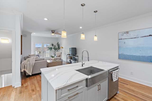 kitchen with stainless steel dishwasher, crown molding, light wood finished floors, and a sink