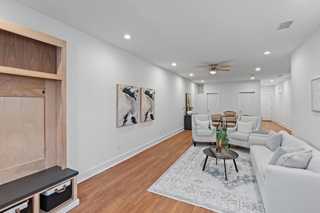 living room with visible vents, a ceiling fan, wood finished floors, recessed lighting, and baseboards