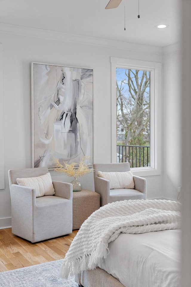 bedroom featuring wood finished floors and crown molding