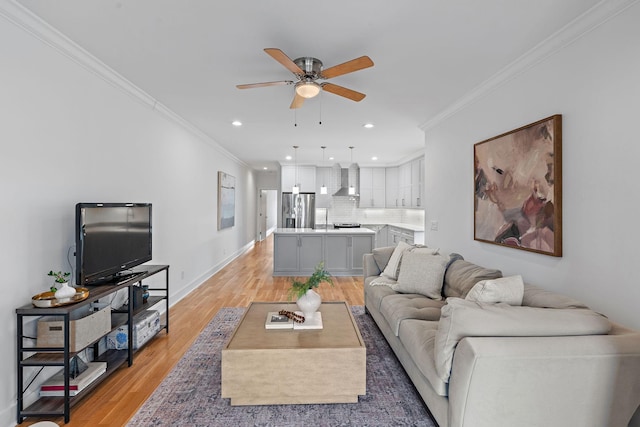 living room with a ceiling fan, baseboards, light wood finished floors, recessed lighting, and crown molding