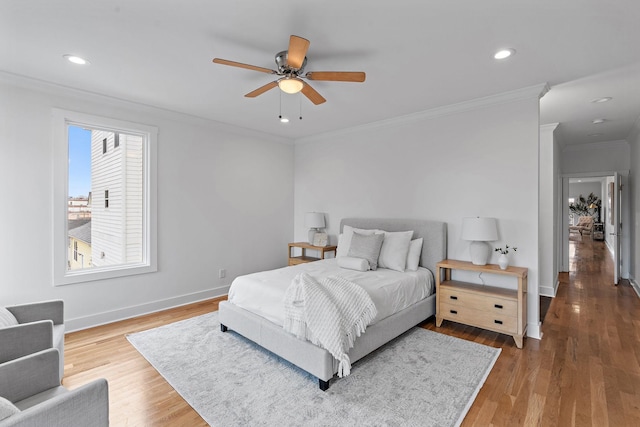 bedroom with ornamental molding, wood finished floors, recessed lighting, baseboards, and ceiling fan