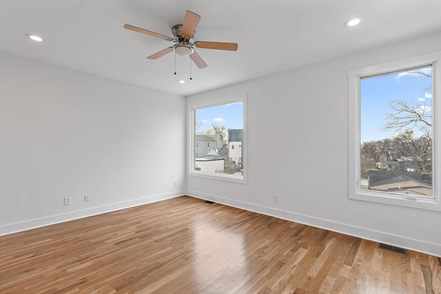 spare room featuring visible vents, recessed lighting, light wood-type flooring, and baseboards