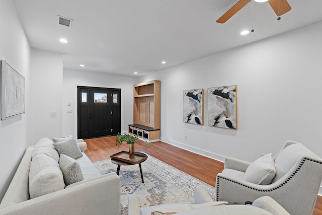 living area with visible vents, recessed lighting, baseboards, and wood finished floors