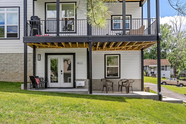 exterior space with a lawn and french doors