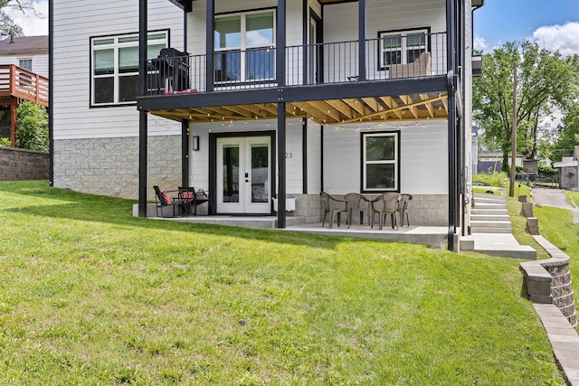 back of property featuring a lawn, french doors, and a patio