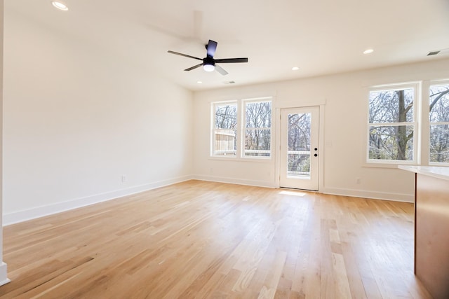 empty room with visible vents, baseboards, recessed lighting, light wood-style flooring, and a ceiling fan