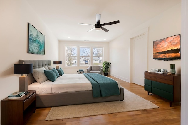 bedroom featuring a ceiling fan, recessed lighting, wood finished floors, and baseboards