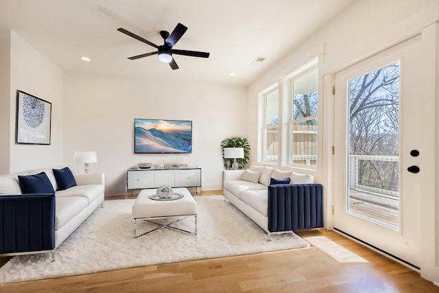 living area featuring wood finished floors, baseboards, visible vents, recessed lighting, and ceiling fan