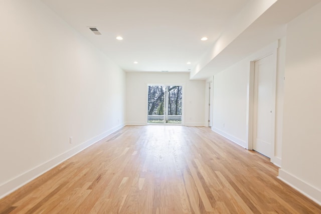 spare room featuring recessed lighting, baseboards, visible vents, and light wood-type flooring