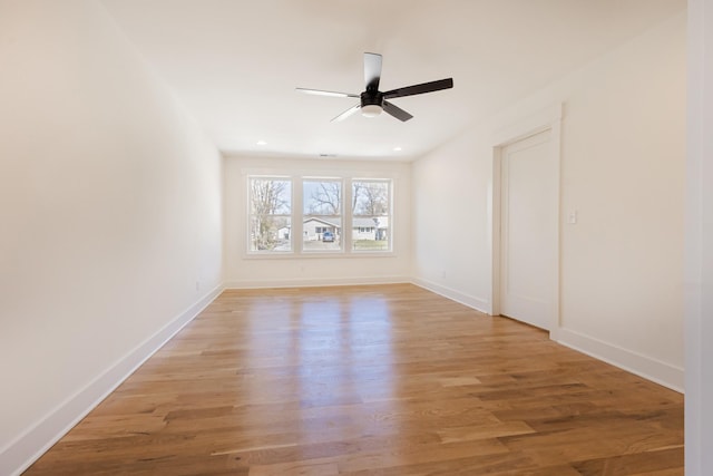 spare room featuring recessed lighting, baseboards, light wood-style flooring, and a ceiling fan