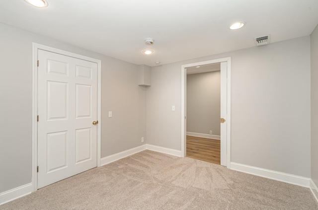 interior space with visible vents, carpet floors, and baseboards