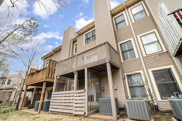 exterior space featuring central AC unit and a chimney