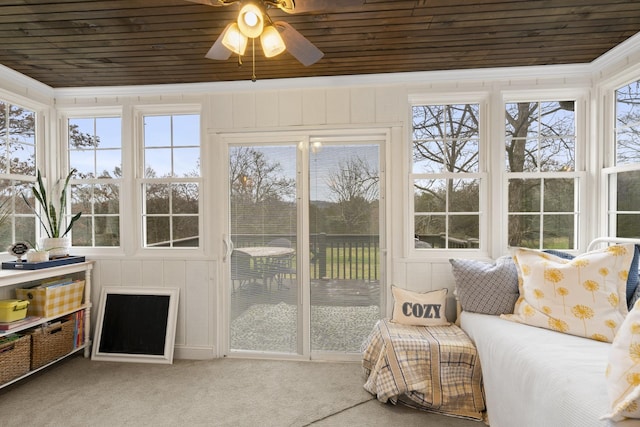 sunroom featuring wooden ceiling and a ceiling fan