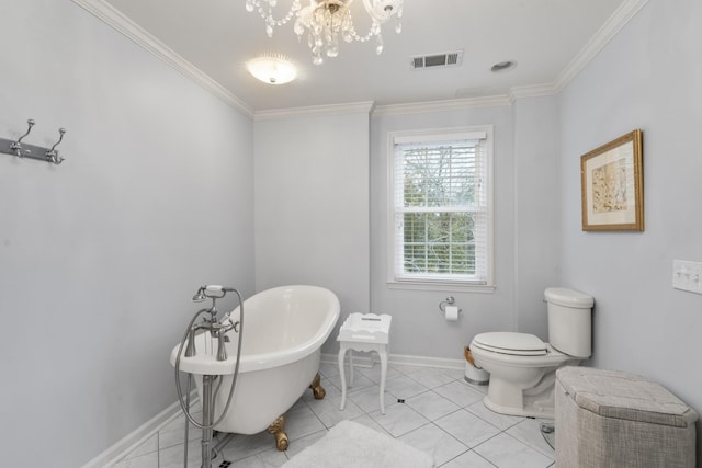 bathroom featuring visible vents, crown molding, baseboards, toilet, and a freestanding tub