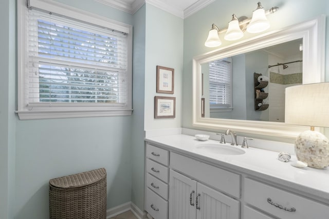 bathroom featuring a tile shower, vanity, and crown molding