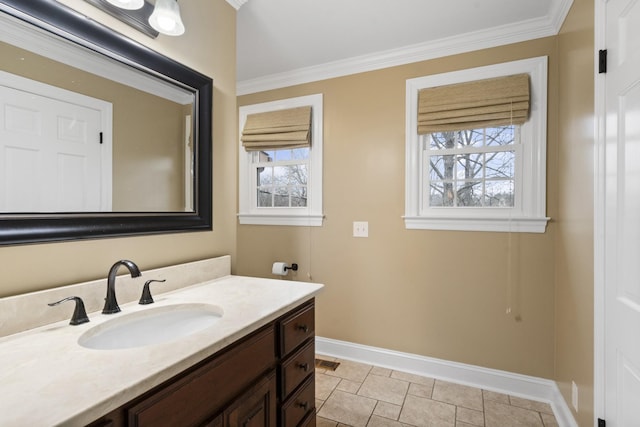 bathroom with vanity, crown molding, visible vents, and baseboards