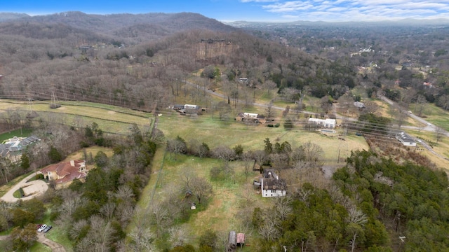 birds eye view of property featuring a rural view, a mountain view, and a forest view