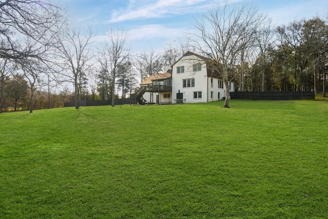 view of yard featuring stairway, a deck, and fence