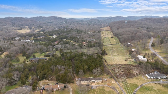 birds eye view of property with a forest view and a mountain view