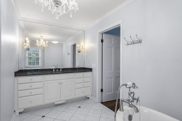 bathroom with a chandelier, ornamental molding, vanity, and a freestanding tub